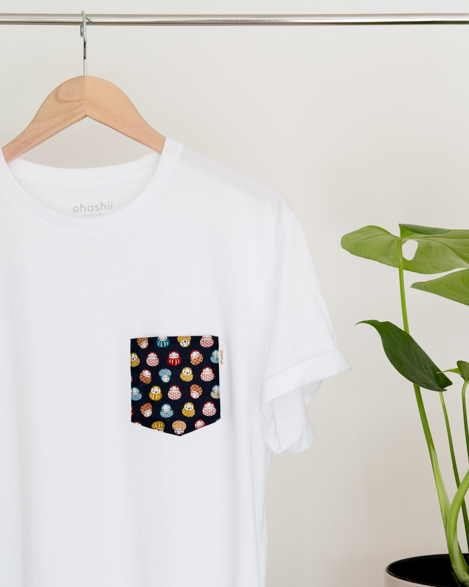 Daruma Pocket Tee hanging on rail